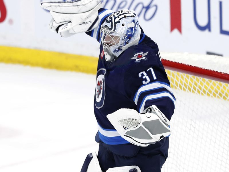 Apr 4, 2024; Winnipeg, Manitoba, CAN; Winnipeg Jets goaltender Connor Hellebuyck (37) celebrates the victory over the Calgary Flames at Canada Life Centre. Mandatory Credit: James Carey Lauder-USA TODAY Sports