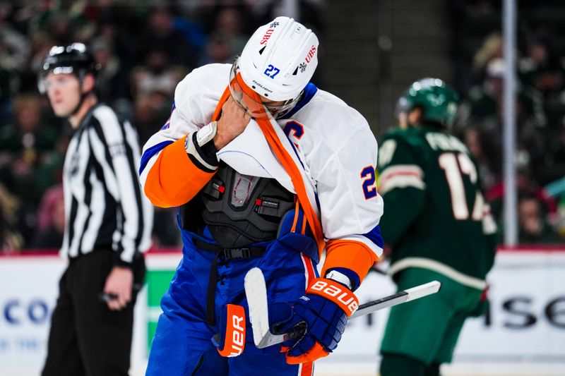 Jan 15, 2024; Saint Paul, Minnesota, USA; New York Islanders left wing Anders Lee (27) wipes his face during the second period against the Minnesota Wild at Xcel Energy Center. Mandatory Credit: Brace Hemmelgarn-USA TODAY Sports