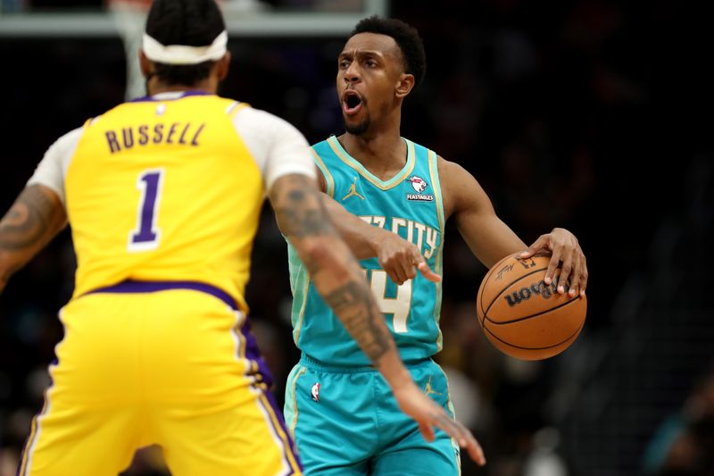 CHARLOTTE, NORTH CAROLINA - FEBRUARY 05: Ish Smith #14 of the Charlotte Hornets shouts instructions as D'Angelo Russell #1 of the Los Angeles Lakers defends during the second half of a game at Spectrum Center on February 05, 2024 in Charlotte, North Carolina. NOTE TO USER: User expressly acknowledges and agrees that, by downloading and or using this photograph, User is consenting to the terms and conditions of the Getty Images License Agreement. (Photo by David Jensen/Getty Images)