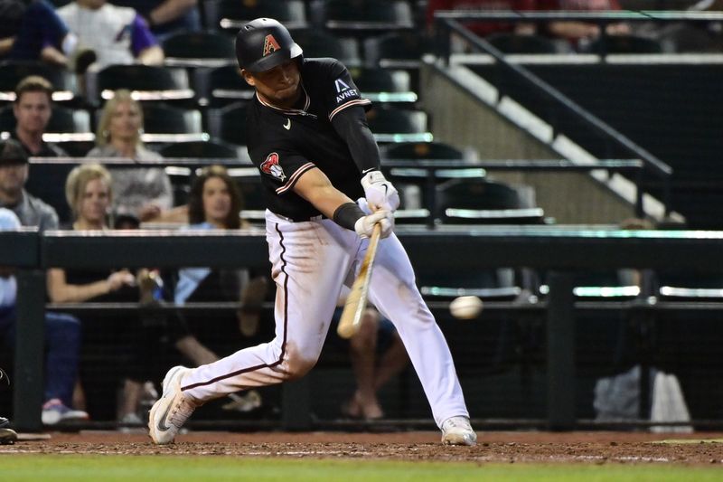 May 8, 2023; Phoenix, Arizona, USA;  Arizona Diamondbacks catcher Gabriel Moreno (14) hits an RBI single in the sixth inning against the Miami Marlins at Chase Field. Mandatory Credit: Matt Kartozian-USA TODAY Sports