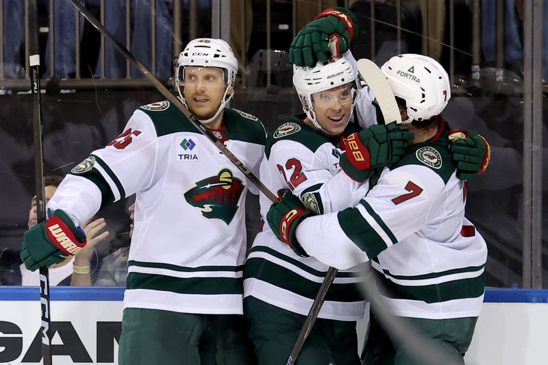 Oct 20, 2025; New York, New York, USA; Minnesota Wild right wing Danila Yurov (22) celebrates his goal against the New York Rangers with defensemen Jonas Brodin (25) and Brock Faber (7) during the third period at Madison Square Garden. Mandatory Credit: Brad Penner-Imagn Images