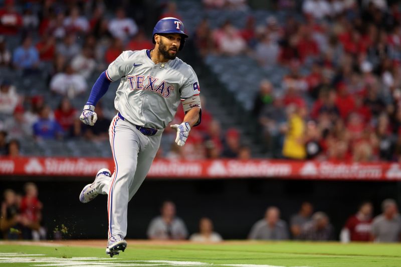 Sep 28, 2024; Anaheim, California, USA;  Texas Rangers second baseman Marcus Semien (2) hits a double during the first inning against the Los Angeles Angels at Angel Stadium. Mandatory Credit: Kiyoshi Mio-Imagn Images