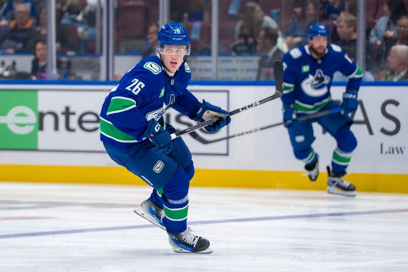 Sep 24, 2024; Vancouver, British Columbia, CAN;  Vancouver Canucks defenseman Elias Pettersson (26) skates against the Seattle Kraken during the second period at Rogers Arena. Mandatory Credit: Bob Frid-Imagn Images