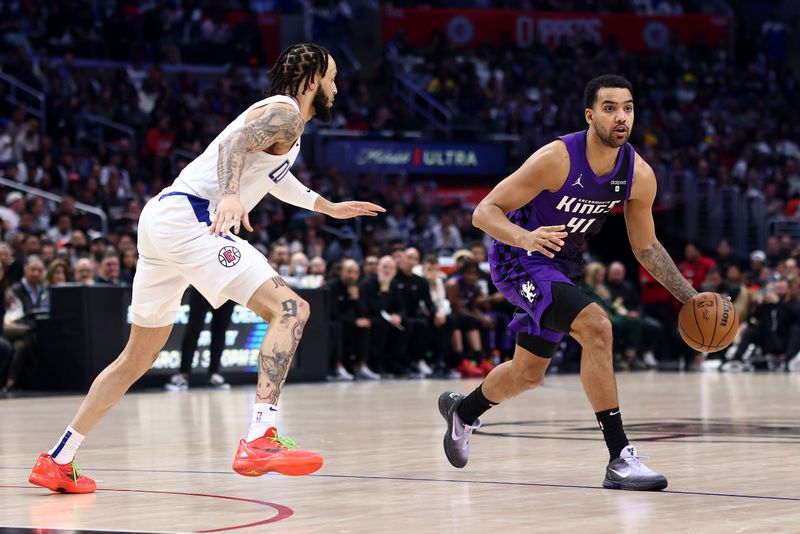 LOS ANGELES, CALIFORNIA - FEBRUARY 25: Trey Lyles #41 of the Sacramento Kings dribbles the ball against Amir Coffey #7 of the Los Angeles Clippers during the third quarter at Crypto.com Arena on February 25, 2024 in Los Angeles, California. The Sacramento Kings defeated the Los Angeles Clippers 123-107. NOTE TO USER: User expressly acknowledges and agrees that, by downloading and or using this photograph, User is consenting to the terms and conditions of the Getty Images License Agreement. (Photo by Katelyn Mulcahy/Getty Images)