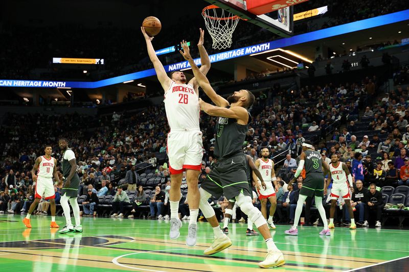 MINNEAPOLIS, MINNESOTA - NOVEMBER 26: Alperen Sengun #28 of the Houston Rockets goes up for a shot against Rudy Gobert #27 of the Minnesota Timberwolves in the third quarter during the Emirates NBA Cup at Target Center on November 26, 2024 in Minneapolis, Minnesota. The Rockets defeated the Timberwolves 117-111 in overtime. NOTE TO USER: User expressly acknowledges and agrees that, by downloading and or using this photograph, User is consenting to the terms and conditions of the Getty Images License Agreement. (Photo by David Berding/Getty Images)