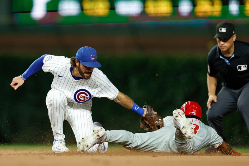 Jul 2, 2024; Chicago, Illinois, USA; Philadelphia Phillies outfielder Johan Rojas (18) is caught stealing second base by Chicago Cubs shortstop Dansby Swanson (7) during the seventh inning at Wrigley Field. Mandatory Credit: Kamil Krzaczynski-USA TODAY Sports