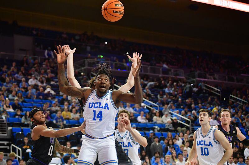 January 14, 2024; Los Angeles, California, USA; UCLA Bruins forward Kenneth Nwuba (14) plays for the rebound against Washington Huskies guard Koren Johnson (0) during the first half at Pauley Pavilion. Mandatory Credit: Gary A. Vasquez-USA TODAY Sports