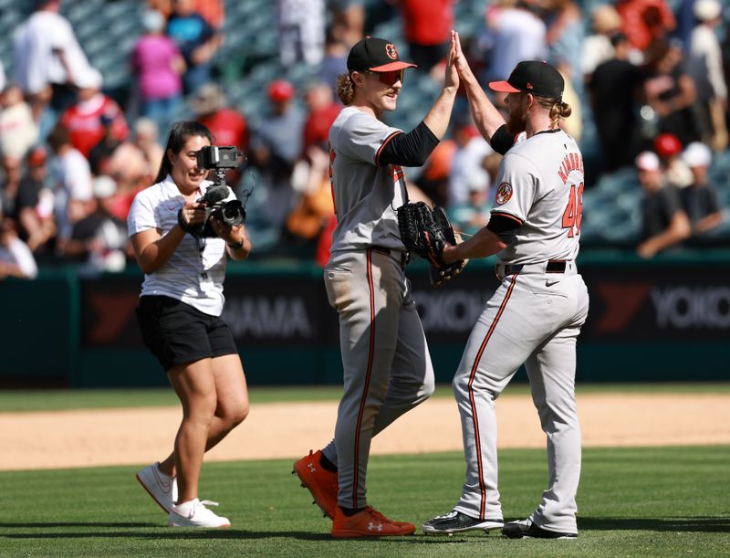 Apr 24, 2024; Anaheim, California, USA;  Baltimore Orioles shortstop Gunnar Henderson (2) and relief pitcher Craig Kimbrel (46) celebrate after a 6-5 win over the Los Angeles Angels at Angel Stadium. Mandatory Credit: Kiyoshi Mio-USA TODAY Sports