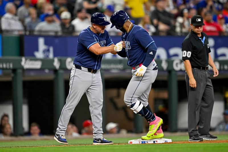 Jul 6, 2024; Arlington, Texas, USA; Tampa Bay Rays first baseman Yandy Diaz (2) rounds the bases past third base coach Brady Williams (4) after Diaz hits a three home run against the Texas Rangers during the seventh inning at Globe Life Field. Mandatory Credit: Jerome Miron-USA TODAY Sports