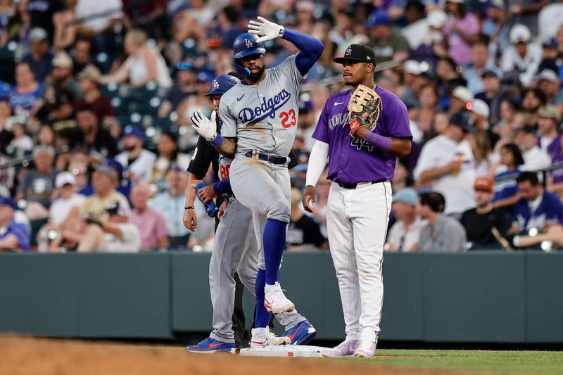 Jun 17, 2024; Denver, Colorado, USA; Los Angeles Dodgers right fielder Jason Heyward (23) reacts from first base ahead of Colorado Rockies first base Elehuris Montero (44) on a single in the seventh inning at Coors Field. Mandatory Credit: Isaiah J. Downing-USA TODAY Sports