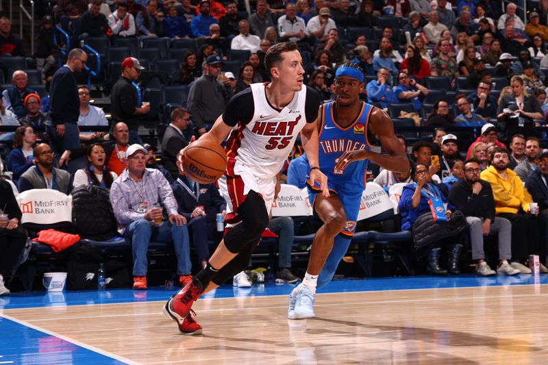 OKLAHOMA CITY, OK - MARCH 8:  Duncan Robinson #55 of the Miami Heat handles the ball during the game against the Oklahoma City Thunder on March 8, 2024 at Paycom Arena in Oklahoma City, Oklahoma. NOTE TO USER: User expressly acknowledges and agrees that, by downloading and or using this photograph, User is consenting to the terms and conditions of the Getty Images License Agreement. Mandatory Copyright Notice: Copyright 2024 NBAE (Photo by Zach Beeker/NBAE via Getty Images)