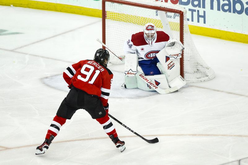 Feb 24, 2024; Newark, New Jersey, USA; New Jersey Devils center Dawson Mercer (91) looks to shoot the puck against Montreal Canadiens goaltender Jake Allen (34) during the third period at Prudential Center. Mandatory Credit: John Jones-USA TODAY Sports