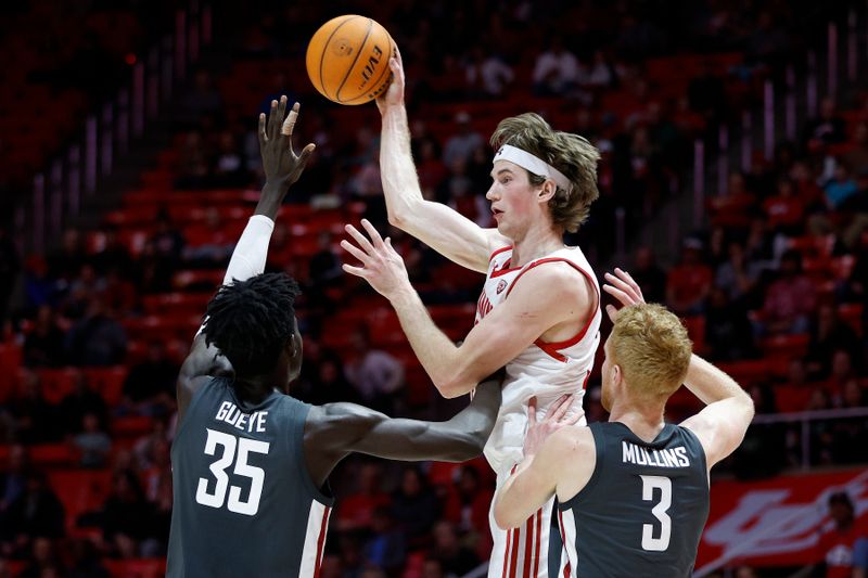 Jan 19, 2023; Salt Lake City, Utah, USA; Utah Utes center Branden Carlson (35) passes against Washington State Cougars forward Mouhamed Gueye (35) and Utah Utes forward Bostyn Holt (3) in the second half at Jon M. Huntsman Center. Mandatory Credit: Jeffrey Swinger-USA TODAY Sports