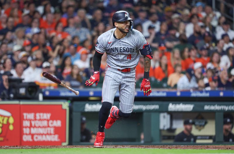 May 31, 2024; Houston, Texas, USA; Minnesota Twins shortstop Carlos Correa (4) hits an RBI double during the third inning against the Houston Astros at Minute Maid Park. Mandatory Credit: Troy Taormina-USA TODAY Sports