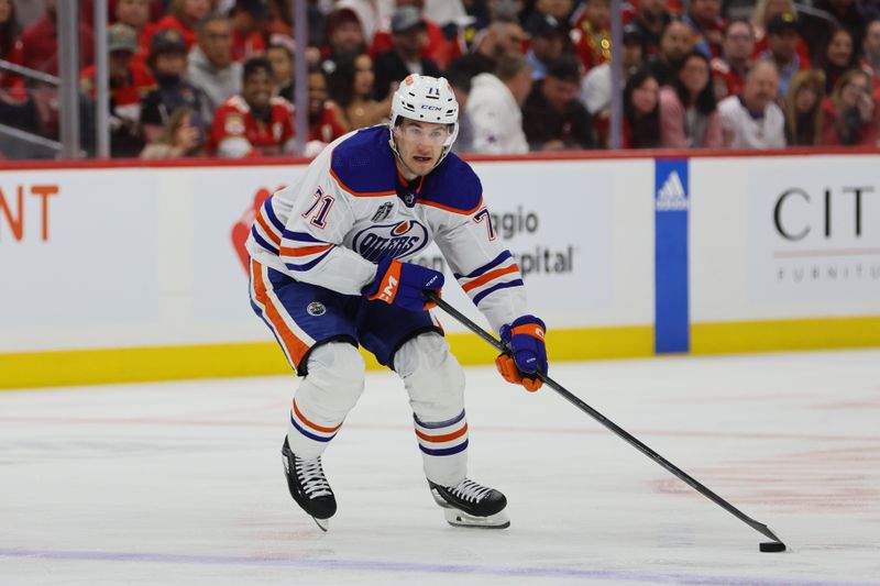 Jun 8, 2024; Sunrise, Florida, USA;  Edmonton Oilers forward Ryan McLeod (71) controls the puck during the first period against the Florida Panters in game one of the 2024 Stanley Cup Final at Amerant Bank Arena. Mandatory Credit: Sam Navarro-USA TODAY Sports