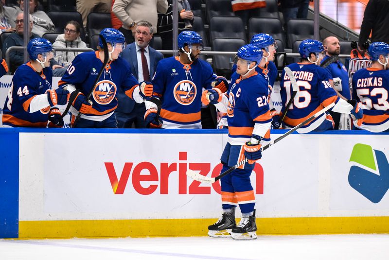 Dec 19, 2025; Elmont, New York, USA; New York Islanders left wing Anders Lee (27) celebrates with teammates after scoring a goal against the Vancouver Canucks during the third period at UBS Arena. Mandatory Credit: John Jones-Imagn Images