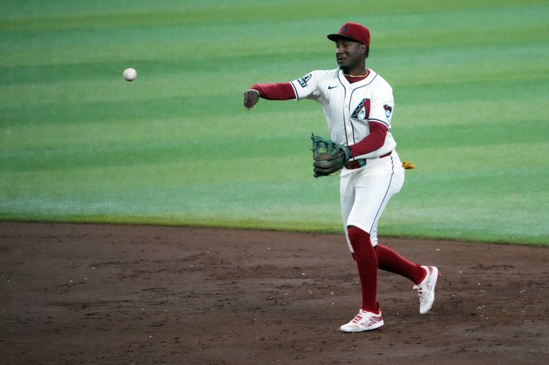 Sep 13, 2024; Phoenix, Arizona, USA; Arizona Diamondbacks shortstop Geraldo Perdomo (2) throws to first base against the Milwaukee Brewers during the sixth inning at Chase Field. Mandatory Credit: Joe Camporeale-Imagn Images