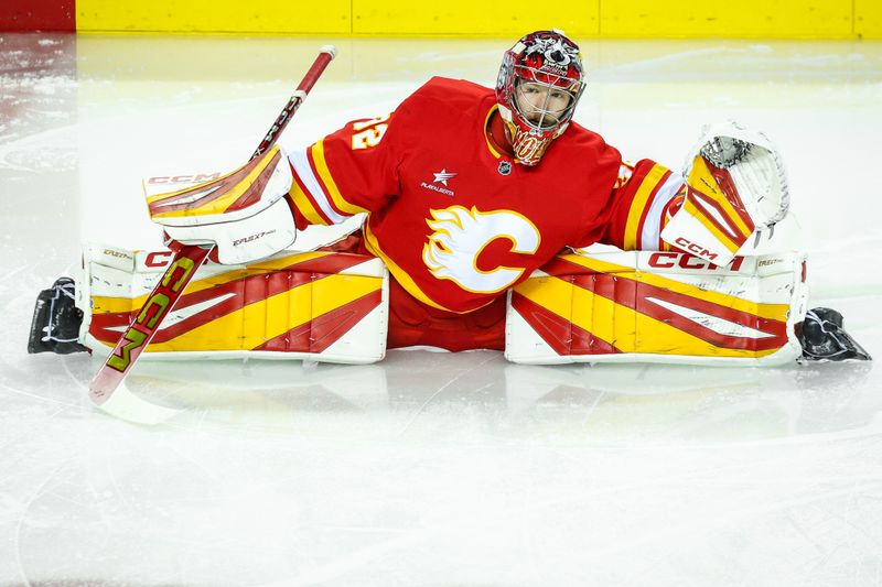 Nov 15, 2024; Calgary, Alberta, CAN; Calgary Flames goaltender Dustin Wolf (32) during the warmup period against the Nashville Predators at Scotiabank Saddledome. Mandatory Credit: Sergei Belski-Imagn Images