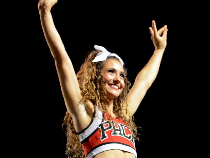 Sep 18, 2021; Raleigh, North Carolina, USA; A North Carolina State Wolfpack cheerleader performs during the first half at Carter-Finley Stadium. Mandatory Credit: Rob Kinnan-USA TODAY Sports