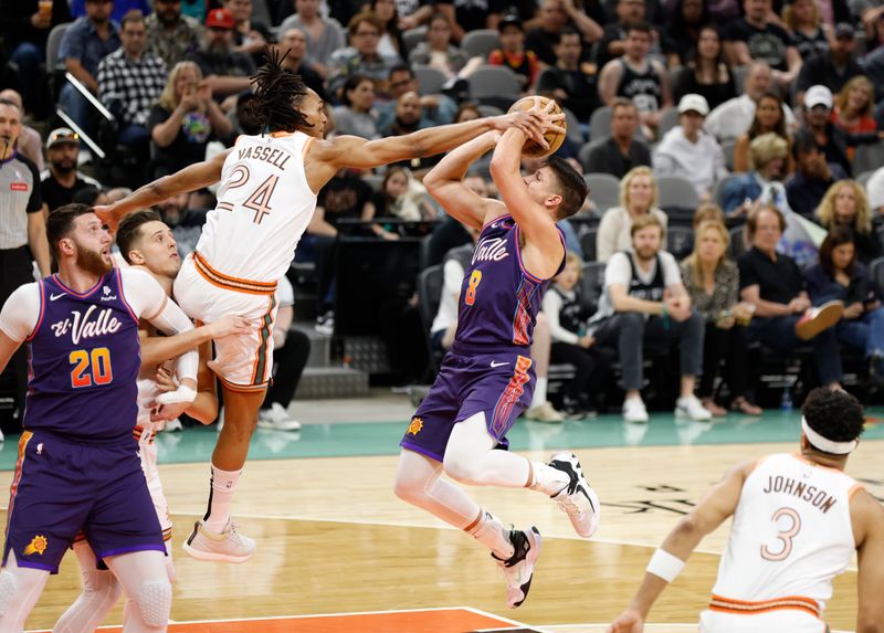 SAN ANTONIO, TX - MARCH 25:  Devin Vassell #24 of the San Antonio Spurs fouls Grayson Allen #8 of the Phoenix Suns going up for a shot in the first half at Frost Bank Center on March 25, 2024 in San Antonio, Texas. NOTE TO USER: User expressly acknowledges and agrees that, by downloading and or using this photograph, User is consenting to terms and conditions of the Getty Images License Agreement. (Photo by Ronald Cortes/Getty Images)