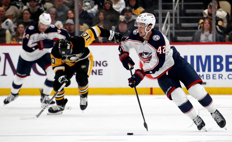 Mar 5, 2024; Pittsburgh, Pennsylvania, USA; Columbus Blue Jackets center Alexandre Texier (42) breaks up ice with the puck against the Pittsburgh Penguins during the second period at PPG Paints Arena. Mandatory Credit: Charles LeClaire-USA TODAY Sports