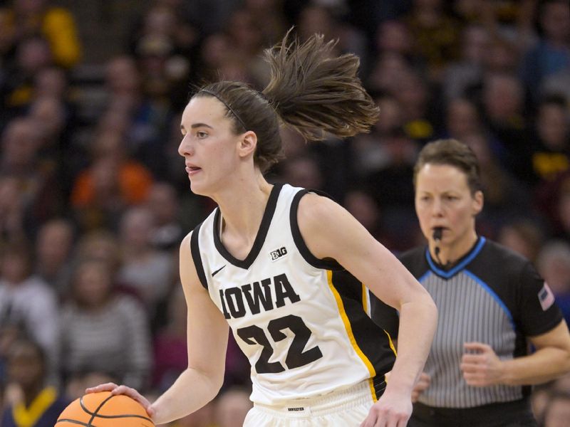 Mar 9, 2024; Minneapolis, MN, USA;  Iowa Hawkeyes guard Caitlin Clark (22) brings the ball up-court against the Michigan Wolverines during the second half of a Big Ten Women's Basketball tournament semifinal at Target Center. Mandatory Credit: Nick Wosika-USA TODAY Sports