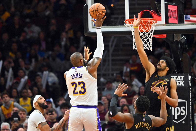 CLEVELAND, OHIO - NOVEMBER 25: LeBron James #23 of the Los Angeles Lakers shoots over Jarrett Allen #31 of the Cleveland Cavaliers during the fourth quarter at Rocket Mortgage Fieldhouse on November 25, 2023 in Cleveland, Ohio. The Lakers defeated the Cavaliers 121-115. NOTE TO USER: User expressly acknowledges and agrees that, by downloading and or using this photograph, User is consenting to the terms and conditions of the Getty Images License Agreement. (Photo by Jason Miller/Getty Images)