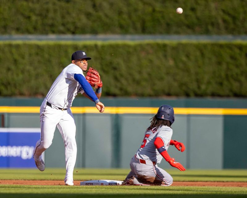 Jun 11, 2024; Detroit, Michigan, USA; Detroit Tigers shortstop Ryan Kreidler (32) turns a double play over Washington Nationals shortstop CJ Abrams (5) at Comerica Park. Mandatory Credit: David Reginek-USA TODAY Sports