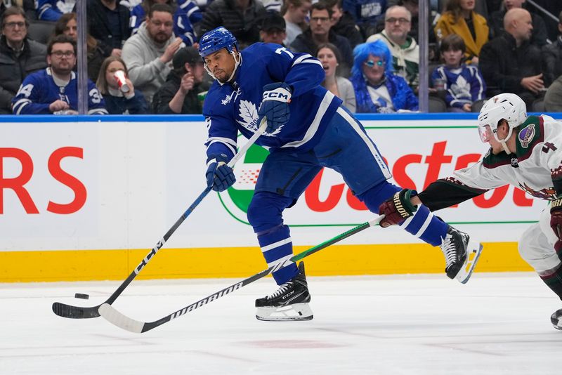 Feb 29, 2024; Toronto, Ontario, CAN; Toronto Maple Leafs forward Ryan Reaves (75) shoots the puck as Arizona Coyotes defenseman Juuso Valimaki (4) defends during the third period at Scotiabank Arena. Mandatory Credit: John E. Sokolowski-USA TODAY Sports