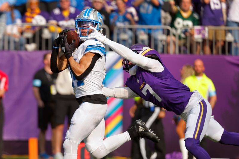 Detroit Lions wide receiver Amon-Ra St. Brown (14) catches a 35-yard touchdown pass as Minnesota Vikings cornerback Byron Murphy Jr. (7) defends during the first half of an NFL football game Sunday, Oct. 20, 2024, in Minneapolis. (AP Photo/Bruce Kluckhohn)