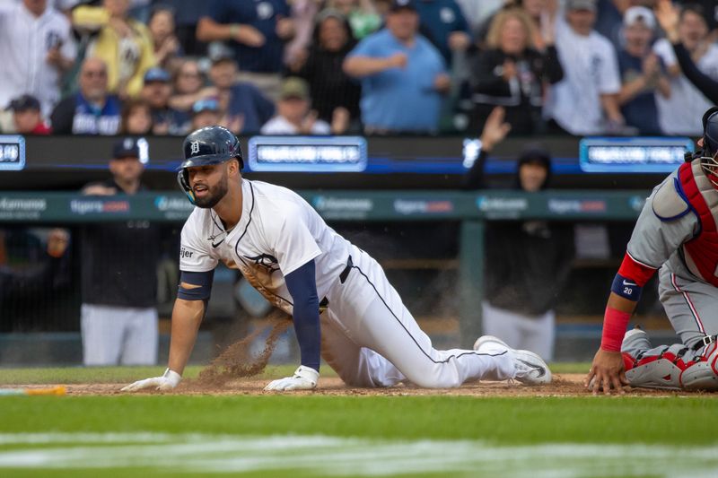 Jun 11, 2024; Detroit, Michigan, USA; Detroit Tigers outfielder Riley Greene (31) scores a run in the fifth inning and beats the throw to Washington Nationals catcher Keibert Ruiz (20) at Comerica Park. Mandatory Credit: David Reginek-USA TODAY Sports