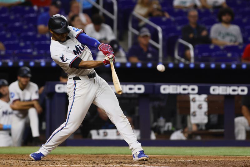 Sep 4, 2024; Miami, Florida, USA; Miami Marlins second baseman Otto Lopez (61) hits an RBI double against the Washington Nationals during the seventh inning at loanDepot Park. Mandatory Credit: Sam Navarro-Imagn Images