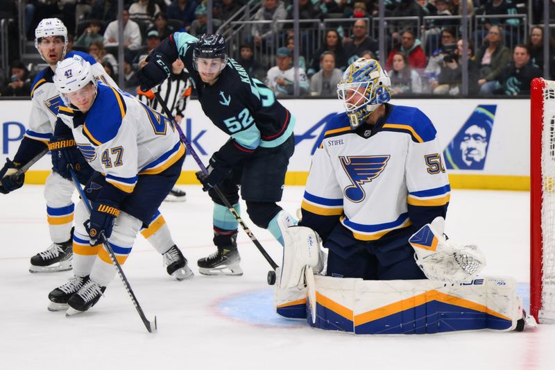 Jan 26, 2024; Seattle, Washington, USA; St. Louis Blues goaltender Jordan Binnington (50) blocks a goal shot against the Seattle Kraken during the second period at Climate Pledge Arena. Mandatory Credit: Steven Bisig-USA TODAY Sports