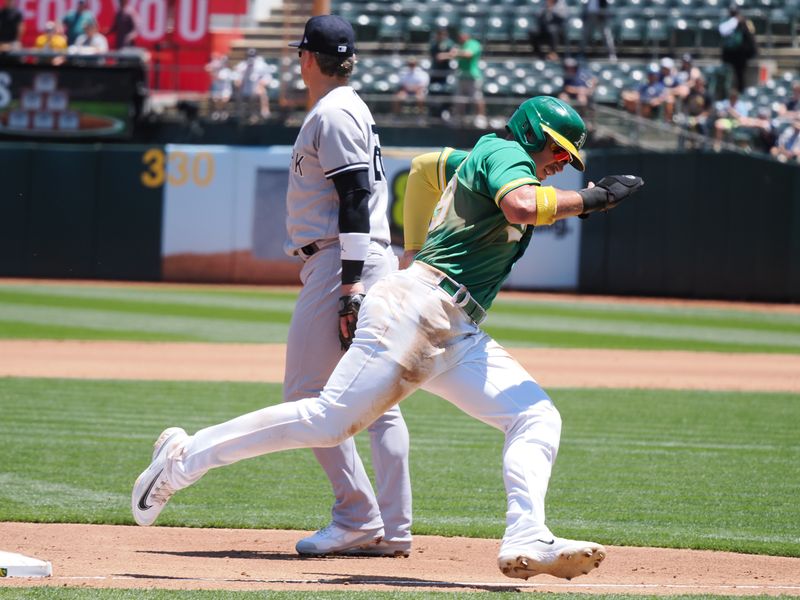 Jun 29, 2023; Oakland, California, USA; Oakland Athletics first baseman Ryan Noda (49) rounds third base behind New York Yankees third baseman Josh Donaldson (28) for a run during the third inning at Oakland-Alameda County Coliseum. Mandatory Credit: Kelley L Cox-USA TODAY Sports