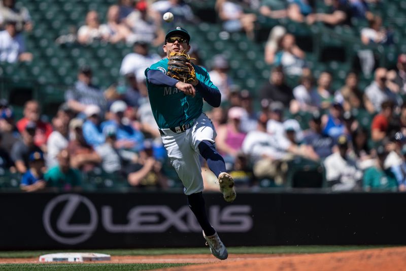 May 15, 2024; Seattle, Washington, USA; Seattle Mariners third baseman Luis Urias (16) throws to first base for an out after fielding a ground ball during the third inning against the Kansas City Royals at T-Mobile Park. Mandatory Credit: Stephen Brashear-USA TODAY Sports