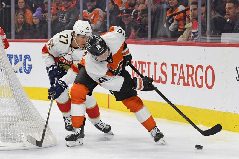 Dec 5, 2024; Philadelphia, Pennsylvania, USA; Philadelphia Flyers right wing Bobby Brink (10) and Florida Panthers center Eetu Luostarinen (27) battle for the puck during the second period at Wells Fargo Center. Mandatory Credit: Eric Hartline-Imagn Images