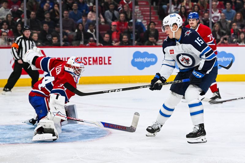 Oct 28, 2023; Montreal, Quebec, CAN; Montreal Canadiens goalie Jake Allen (34) makes a save against Winnipeg Jets center Rasmus Kupari (15) during the third period at Bell Centre. Mandatory Credit: David Kirouac-USA TODAY Sports