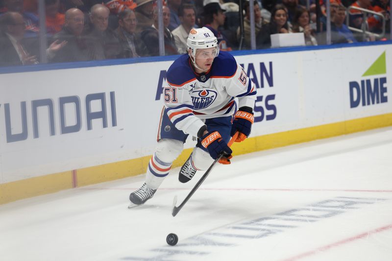 Mar 14, 2025; Elmont, New York, USA; Edmonton Oilers defenseman Troy Stecher (51) skates with the puck against the New York Islanders during the second period at UBS Arena. Mandatory Credit: Thomas Salus-Imagn Images