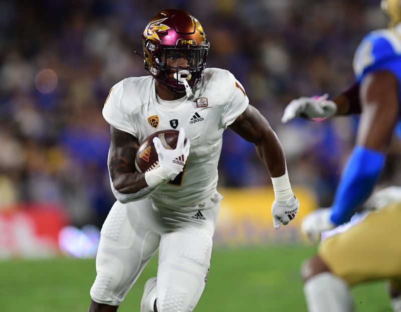 Oct 2, 2021; Pasadena, California, USA; Arizona State Sun Devils running back DeaMonte Trayanum (1) runs the ball against the UCLA Bruins during the first half at Rose Bowl. Mandatory Credit: Gary A. Vasquez-USA TODAY Sports