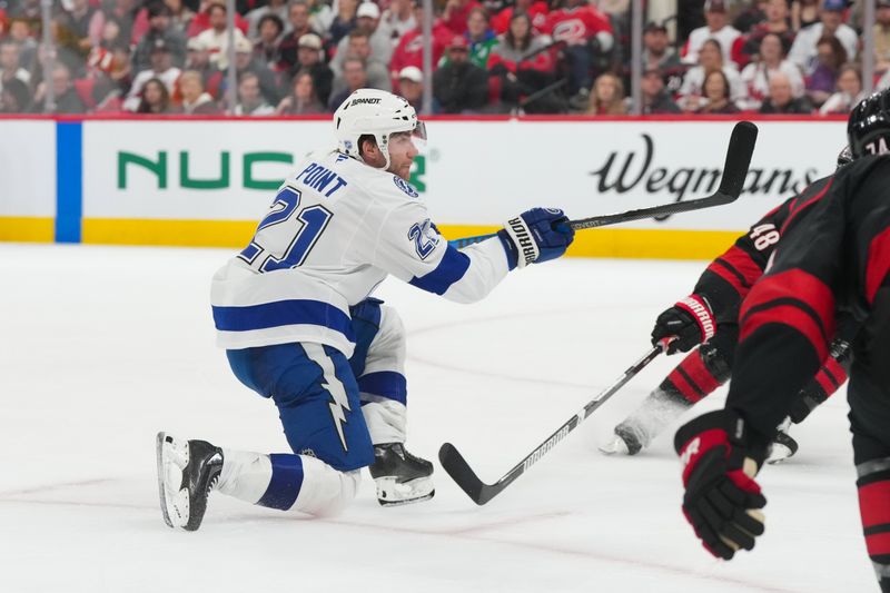 Feb 26, 2026; Raleigh, North Carolina, USA;  Tampa Bay Lightning center Brayden Point (21) scores a goal against the Carolina Hurricanes during the second period at Lenovo Center. Mandatory Credit: James Guillory-Imagn Images