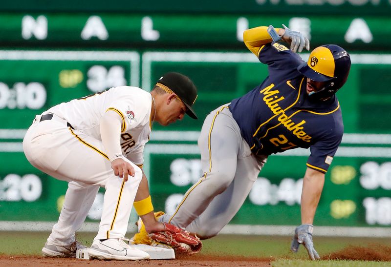 Sep 24, 2024; Pittsburgh, Pennsylvania, USA; Milwaukee Brewers shortstop Willy Adames (27) steals second base ahead of a tag attempt by Pittsburgh Pirates second baseman Nick Gonzales (left) during the second inning at PNC Park. Mandatory Credit: Charles LeClaire-Imagn Images