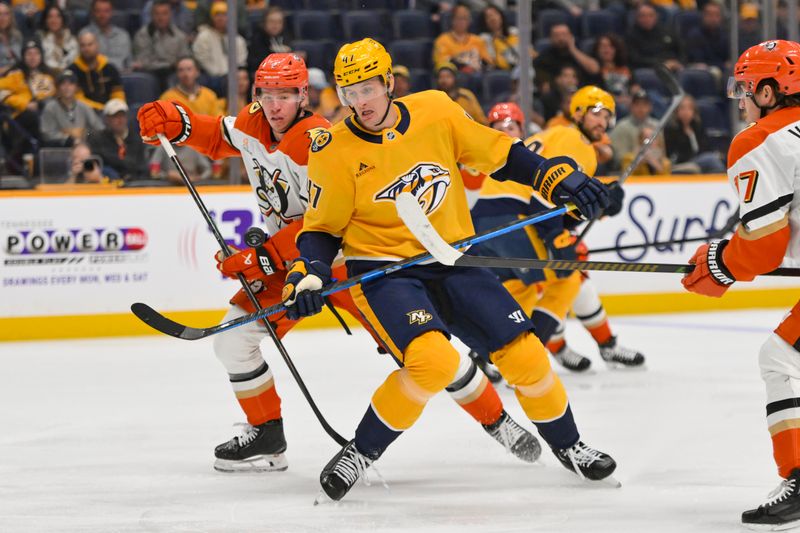Oct 21, 2025; Nashville, Tennessee, USA;  Nashville Predators right wing Michael McCarron (47) and Anaheim Ducks defenseman Jackson Lacombe (2) battle for the puck during the first period at Bridgestone Arena. Mandatory Credit: Steve Roberts-Imagn Images