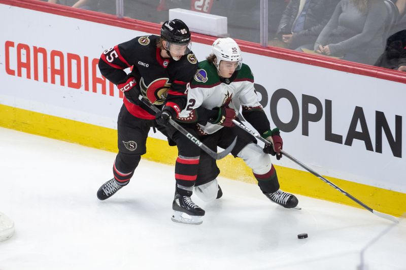 Mar 1, 2024; Ottawa, Ontario, CAN; Ottawa Senators defenseman Jake Batherson (85) battles with Arizona Coyotes center Logan Cooley (92) in the third period at the Canadian Tire Centre. Mandatory Credit: Marc DesRosiers-USA TODAY Sports