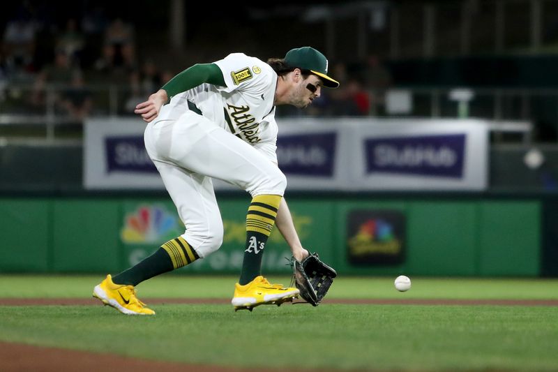 Sep 27, 2025; West Sacramento, California, USA; Athletics shortstop Jacob Wilson (5) fields a ball against the Kansas City Royals during the first inning at Sutter Health Park. Mandatory Credit: Dennis Lee-Imagn Images