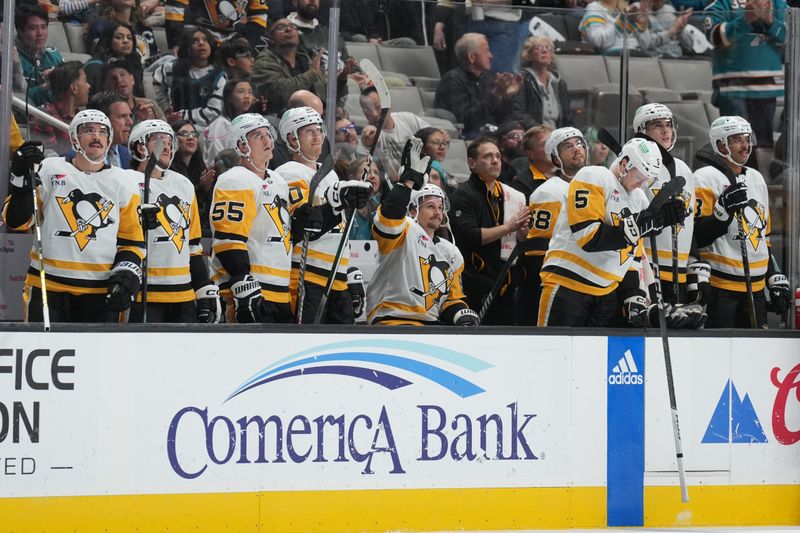 Nov 4, 2023; San Jose, California, USA; Pittsburgh Penguins defenseman Erik Karlsson (center with arm raised) acknowledges the fans after a video tribute was played on the main scoreboard during the first period against the San Jose Sharks at SAP Center at San Jose. Mandatory Credit: Darren Yamashita-USA TODAY Sports