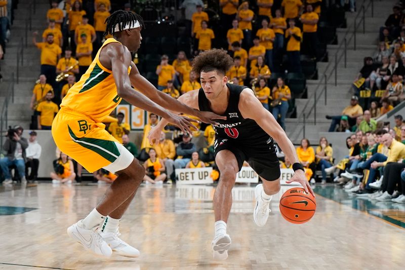 Jan 13, 2024; Waco, Texas, USA; Cincinnati Bearcats guard Dan Skillings Jr. (0) works on  Baylor Bears guard Ja'Kobe Walter (4) during the first half at Paul and Alejandra Foster Pavilion. Mandatory Credit: Raymond Carlin III-USA TODAY Sports