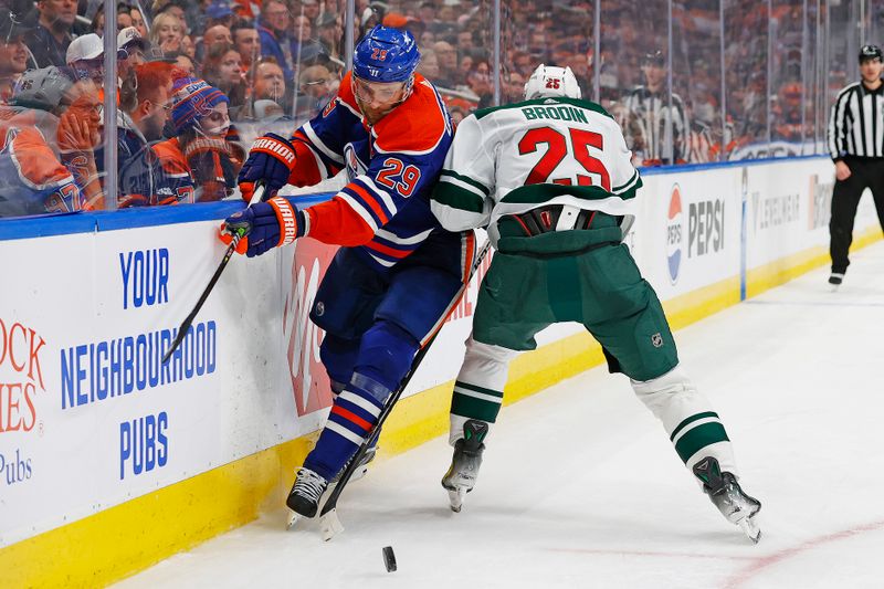 Feb 23, 2024; Edmonton, Alberta, CAN; Edmonton Oilers forward Leon Draisaitl (29) and Minnesota Wild defensemen Jonas Brodin (25) Battle along the boards for a loose puck  during the third period at Rogers Place. Mandatory Credit: Perry Nelson-USA TODAY Sports