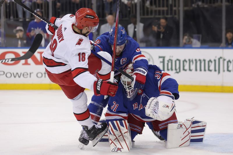 May 13, 2024; New York, New York, USA; Carolina Hurricanes center Jack Drury (18) collides with New York Rangers defenseman Jacob Trouba (8) and goaltender Igor Shesterkin (31) during the first period of game five of the second round of the 2024 Stanley Cup Playoffs at Madison Square Garden. Mandatory Credit: Brad Penner-USA TODAY Sports