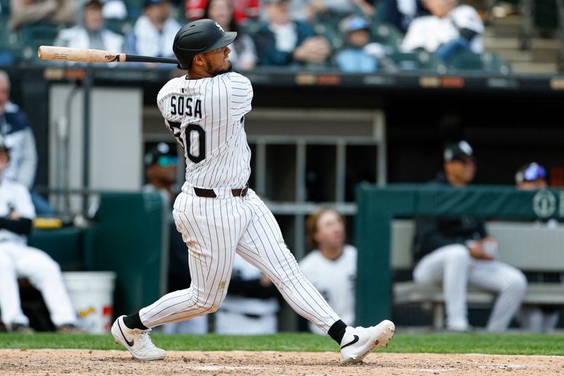 May 24, 2025; Chicago, Illinois, USA; Chicago White Sox second baseman Lenyn Sosa (50) hits a three-run double against the Texas Rangers during the sixth inning at Rate Field. Mandatory Credit: Kamil Krzaczynski-Imagn Images