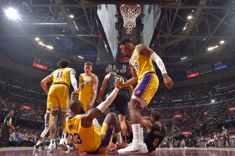 CLEVELAND, OH - OCTOBER 30: LeBron James #23 of the Los Angeles Lakers is helped up during the game against the Cleveland Cavaliers on October 30, 2024 at Rocket Mortgage FieldHouse in Cleveland, Ohio. NOTE TO USER: User expressly acknowledges and agrees that, by downloading and/or using this Photograph, user is consenting to the terms and conditions of the Getty Images License Agreement. Mandatory Copyright Notice: Copyright 2024 NBAE (Photo by David Liam Kyle/NBAE via Getty Images)